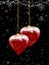 Christmas baubles heart shaped and snow on festive background