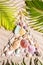 Christmas beach background with a creative arrangement of seashells forming a Xmas tree on the textured sand with ribbed lines and