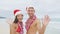 Christmas beach Hawaii couple waving hands hello