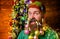 Christmas beard decorations. Happy bearded man with dyed hair and decorated beard ready for New year party. Smiling man