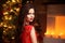 Christmas. Beautiful smiling woman. Makeup. Elegant lady in red