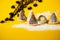 Christmas beehive cake on snowy yellow background, copy space