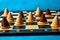 Christmas beehive cake on wooden chessboard on blue background