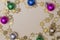 Christmas beige background with bright fir tree, colorful toys and gold decoration