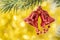 Christmas bell ornament hang on tree branch with yellow bokeh ba