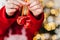 Christmas Bells .child holding red and white decorative bells in his hand on a shining Christmas tree background.Holiday