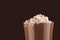 Christmas beverage - hot chocolate with marshmallows, cocoa powder closeup, details, top section in elegant dark brown background.