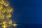 Christmas blank interior with glow lights yellow stars on indigo blue wood background.