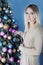 Christmas blonde woman hanging a ball