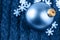 Christmas blue ball on a wool weaving background with decorative snow