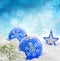 Christmas blue baubles on snow background