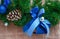 Christmas blue ribbon on green New Year tree branch