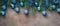 Christmas border, fir branches decorated blue balls and tinsel on a dark textured rustic background. Top view, flat lay, copy