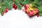 Christmas border. Green Xmas fir branch, red holly berries, gift, candy and baubles. Christmas composition, top view flat lay