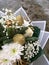 Christmas bouquet of fresh Nobilis, gold apple, white roses, white ball. A bouquet of fresh nobilis, gold leaf, fir branches,