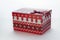 Christmas box with red gifts on white isolated background with the image of Christmas trees close-up angled