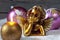 Christmas bulbs burning candle golden putto on pile of snow