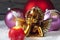 Christmas bulbs burning candle golden putto on pile of snow