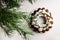 Christmas Bundt cake with white glaze and spruce branches over light background. Top view. Copy space.