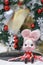 Christmas bunny. A cute rabbit doll wearing a Christmas festive red dress and holding a candy cane with Christmas wreath on the