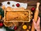Christmas cake baking rolling pin in hand rustic wooden background flatlay Dough recipe ingredient eggs wholegrain flour