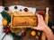 Christmas cake baking rolling pin in hand rustic wooden background flatlay Dough recipe ingredient eggs wholegrain flour