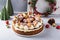 Christmas cake decorated with gingerbread cookies and sugared cranberries, holiday cheesecake idea