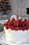 A Christmas cake topped with berries