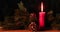 Christmas candle burning on the wooden table
