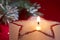 Christmas candle star in red closeup