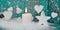 Christmas candle in white with turquoise hearts, wood and snow f