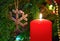 Christmas - candle and wooden snowflake on fir