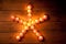 Christmas candles pentagram star on wood