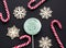 Christmas candy cane, mint marshmallow, white snowflake on black background. Christmas background.