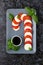 Christmas caprese salad in form of candy cane. Mozzarella and tomato on grey plate served for New year