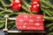 Christmas card. Bright red Santa`s sleigh with snowflakes on the background of a Christmas tree and a wooden baby in bright red