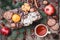 Christmas card. Christmas Cookies Chocolate, tea, pomegranate, Tangerines, Nuts, cocoa beans, Fir branches on wooden table