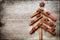 Christmas card with Christmas fir tree made from spices cinnamon sticks, anise star and cane sugar on rustic wooden background