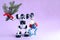 Christmas card for cyber businesses. Toy robot with fir branches in one hand and christmas tree toys in another on violet