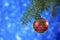 Christmas card. red Christmas ball hanging on your Christmas tree on a blue background