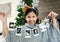 Christmas, celebration and girl with polaroid for decoration, happy and show photos in the house. Smile, excited and