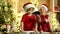 Christmas chef cook - children in Santa hat. Two children make gingerbread cookie for Santa against Christmas light