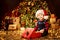 Christmas Child Open Present under Xmas Tree, Happy Baby Boy