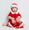 Christmas child in Santa hat opening Xmas gift box