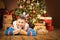 Christmas Child under Xmas Tree, Happy Boy Presents Gifts