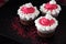 Christmas chocolate cupcakes pink cream cheese frosting. Dark background. Selective focus