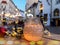 Christmas city, street cafe table with candle light glass cup ,evening blurred light, tourist people walking in the street in Tall