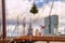 Christmas cityscape - view of the skyscrapers of district Feijenoord through the rigging of the moored sailboat with Christmas tre