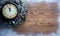 Christmas clock over snow wooden background.