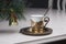 Christmas coffee concept. Golden coffee cup, bell and new year tree branch in cafe. Luxurious elegance style